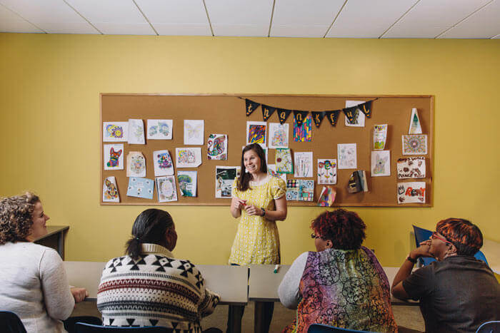 An ambassador connects with women at Restoration House.