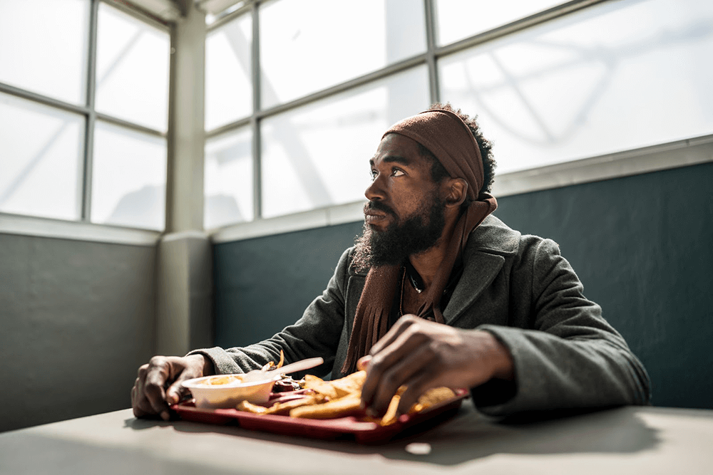 man eating lunch at Transitional Housing