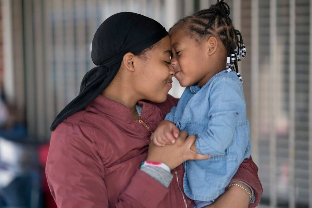 mother and daughter showing how to help those facing homelessness this Christmas