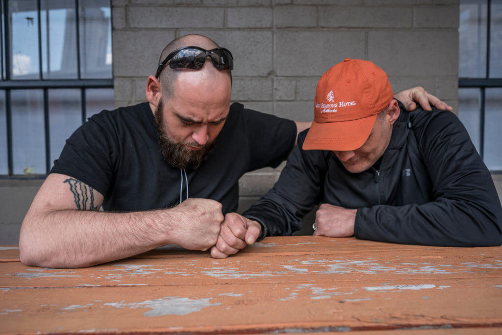 two men praying together