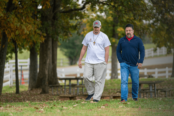 two men walking outside at the potter's house