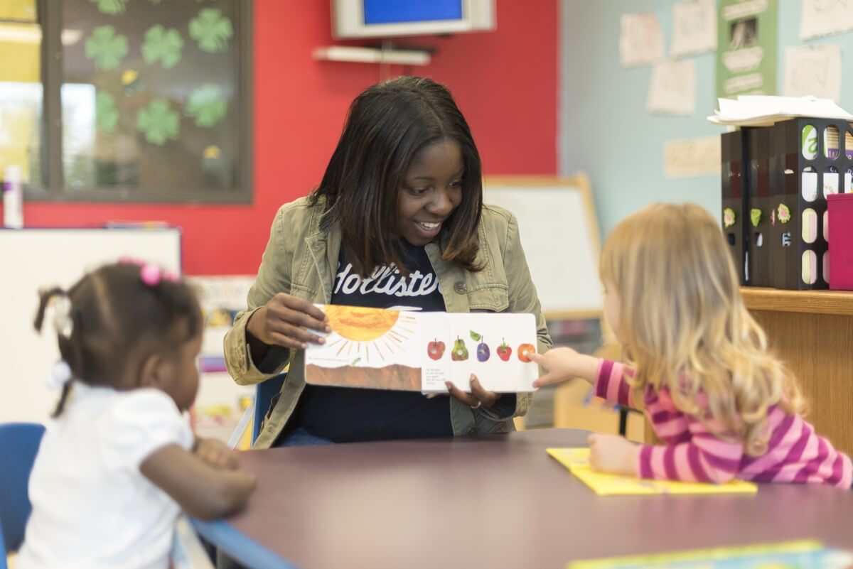 woman teaching children in a classroom
