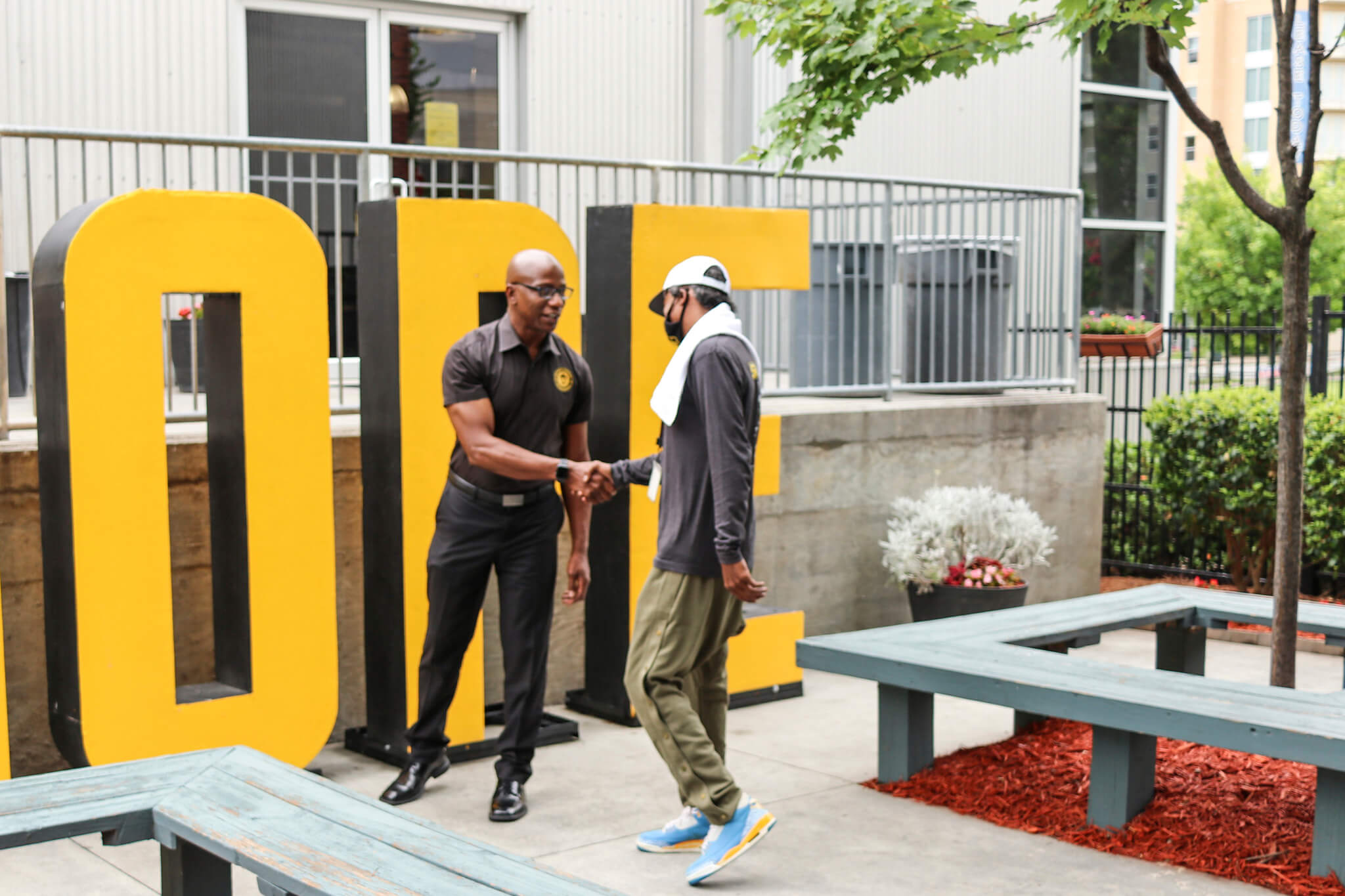 one of our staff members will wilson shaking hands with a client at atlanta mission