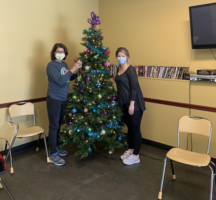 Two women decorating a tree for Christmas at Atlanta Mission