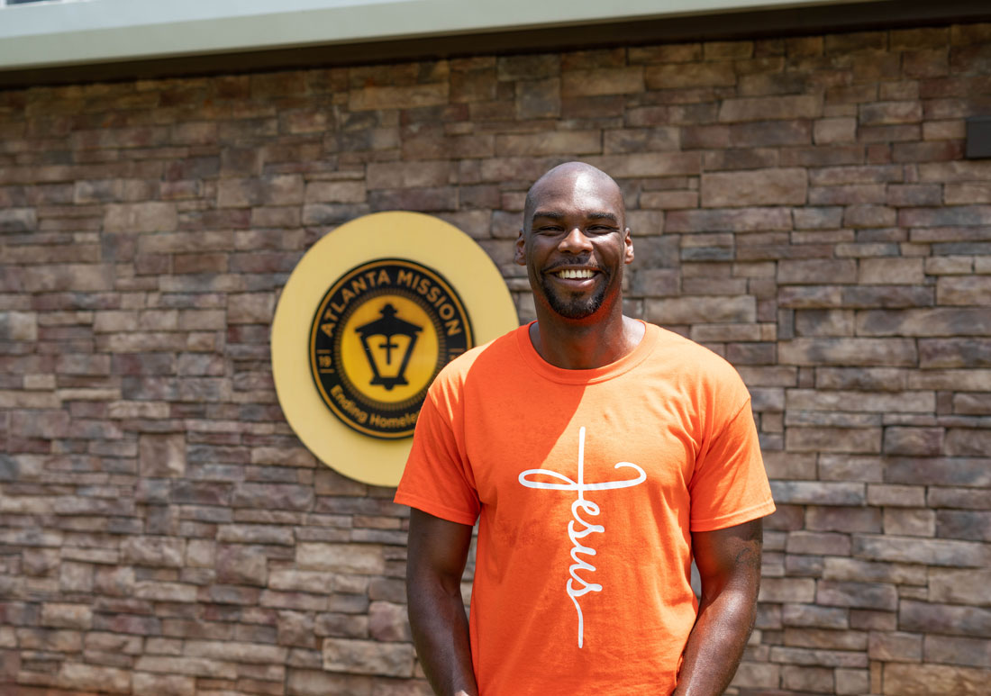 Terrence standing in front of Atlanta Mission sign at TPH.