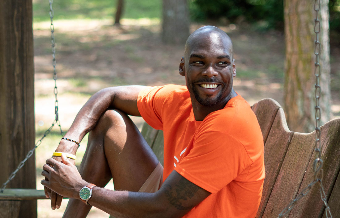 Terrence sitting outside smiling.