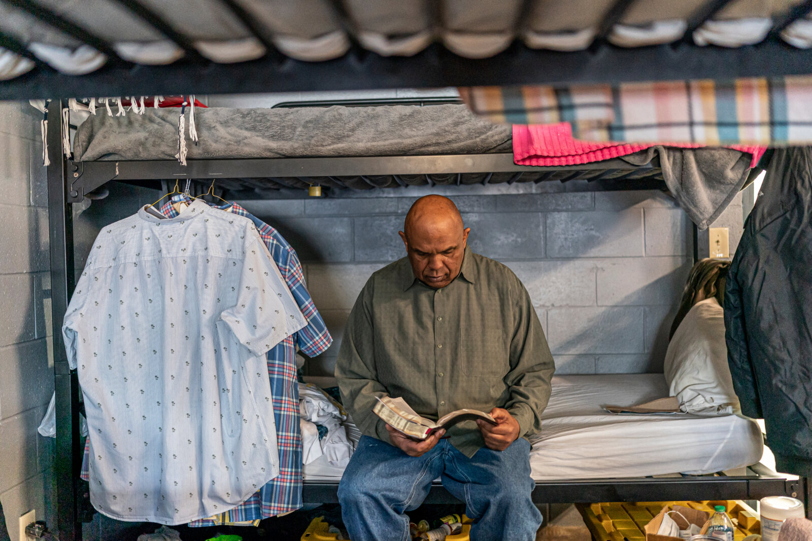 Man sitting down reading a Bible at Atlanta Mission