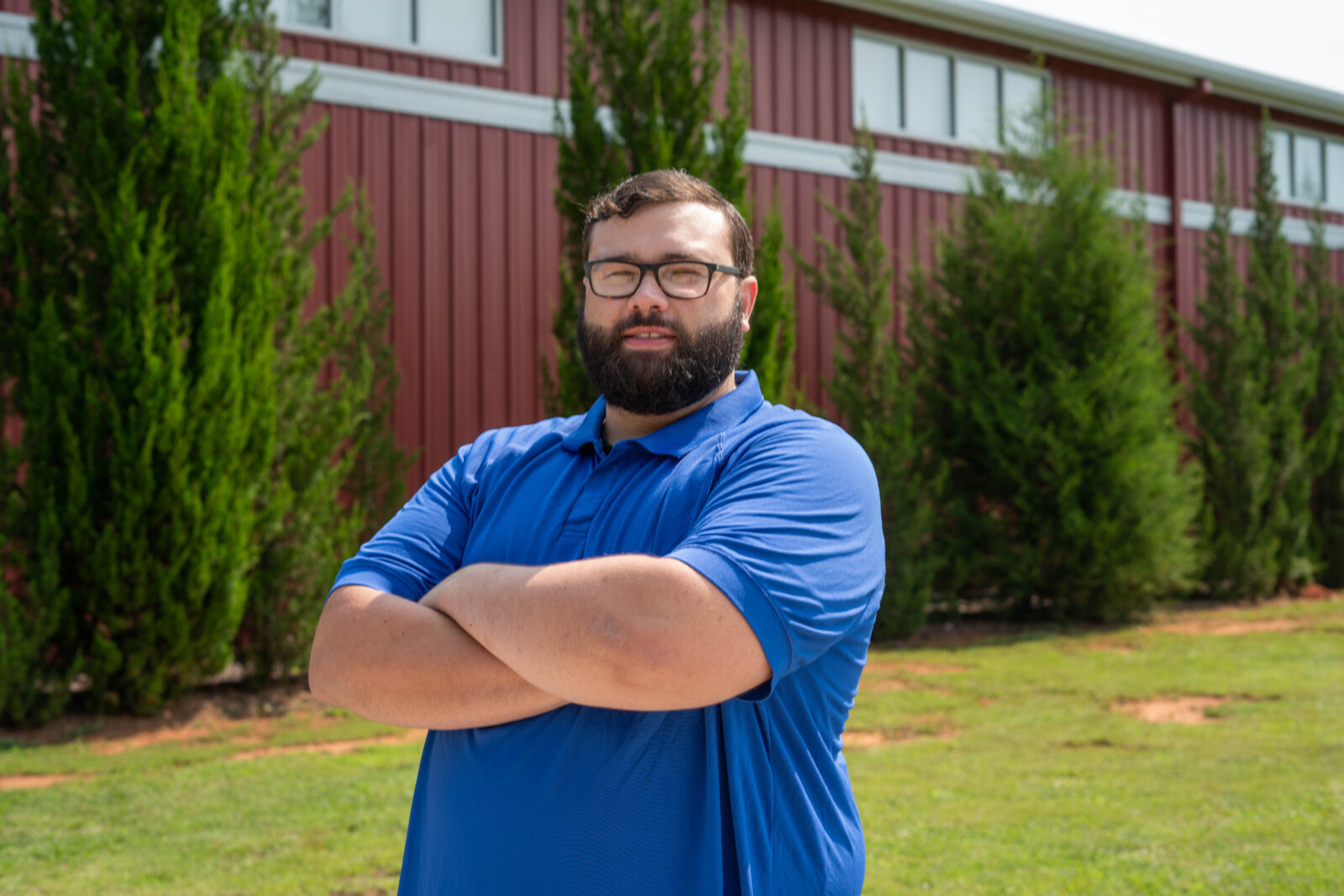 Brandon standing outside of The Potter's House