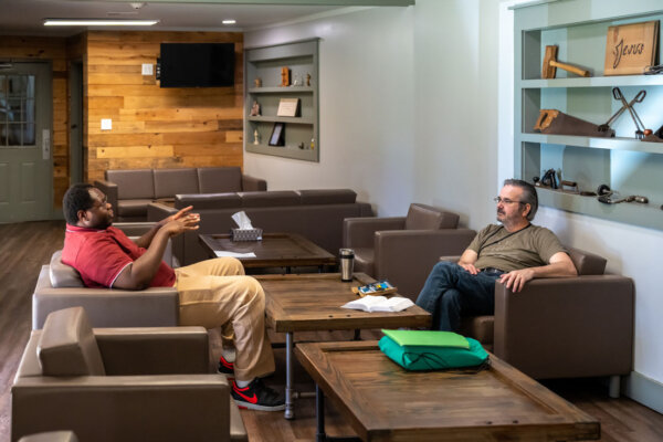 Men talking in lounge area at The Potter's House