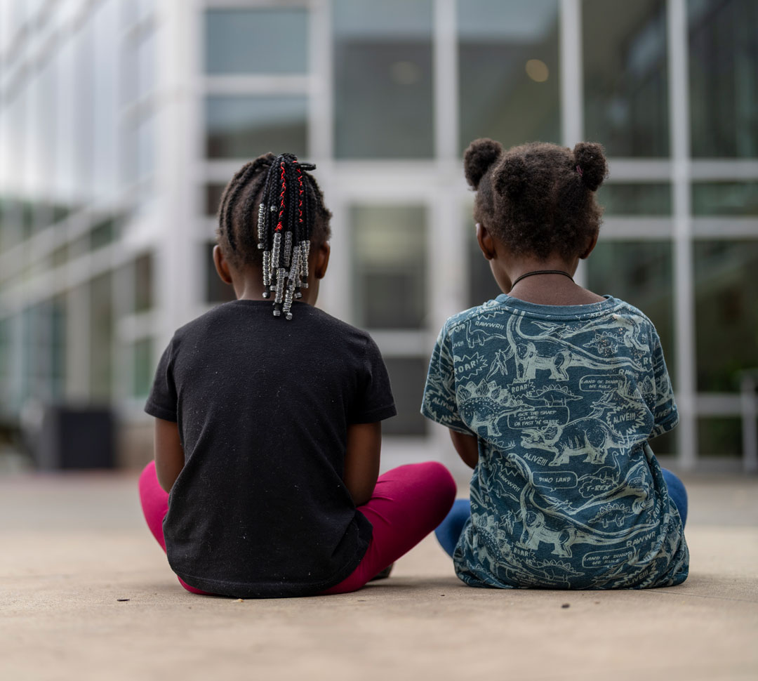 two girls sitting on the group at MSH