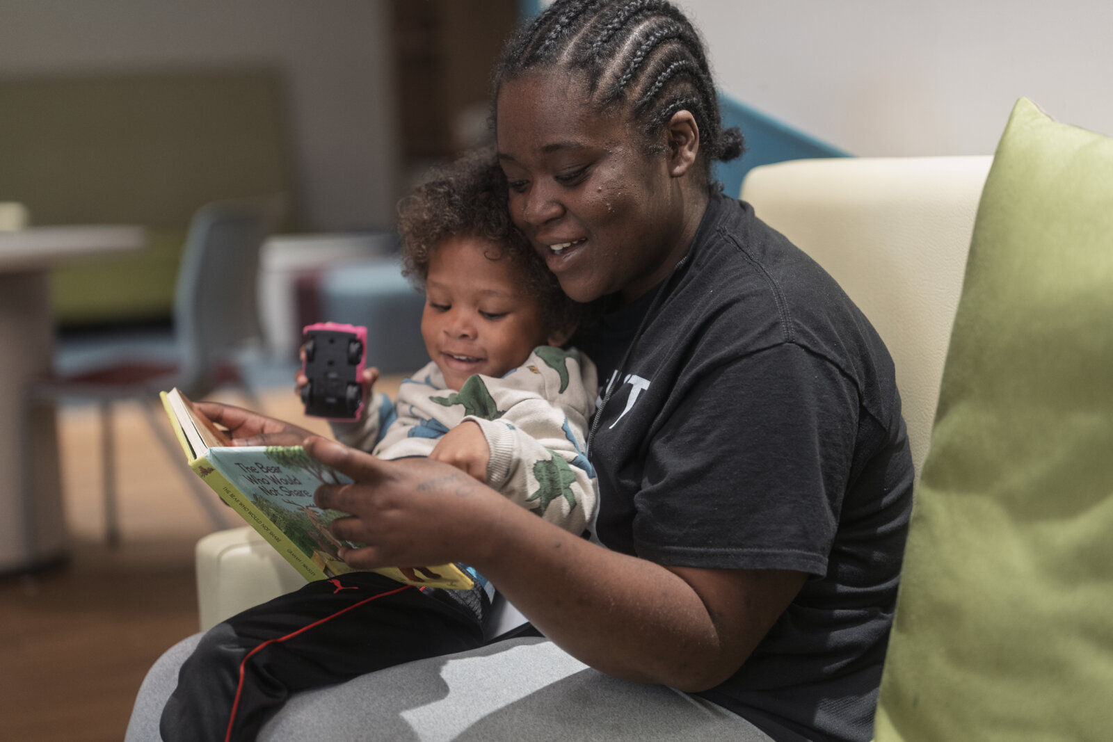A mother and son read a book together at Restoration House