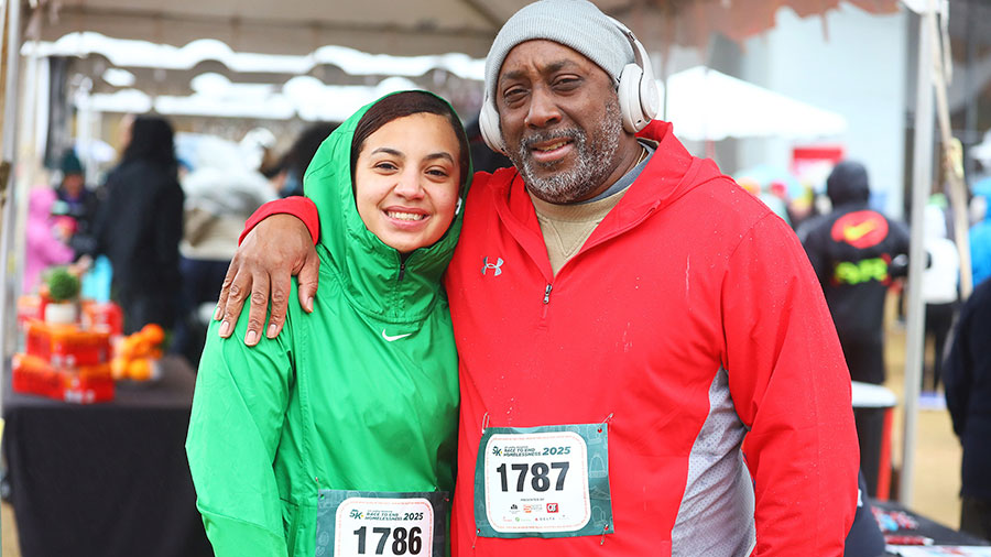 Man and woman smiling at camera at race