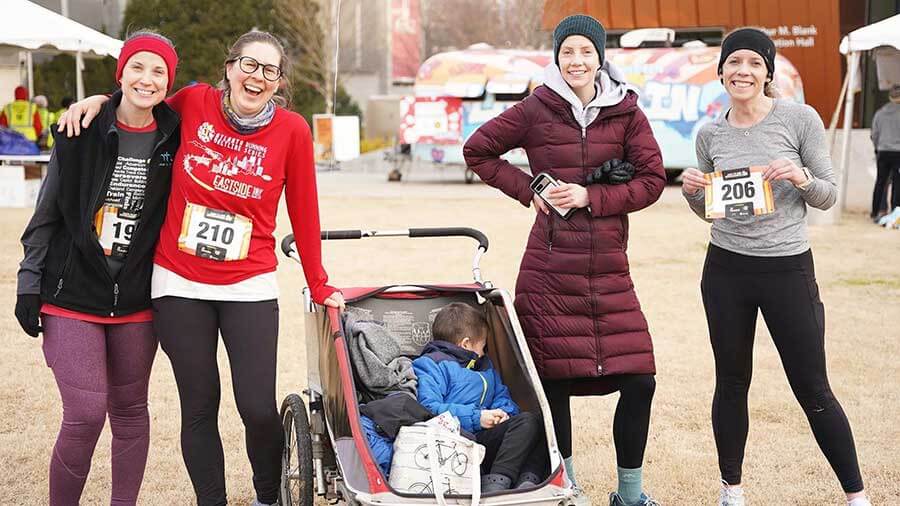 Group of women posing with a stroller